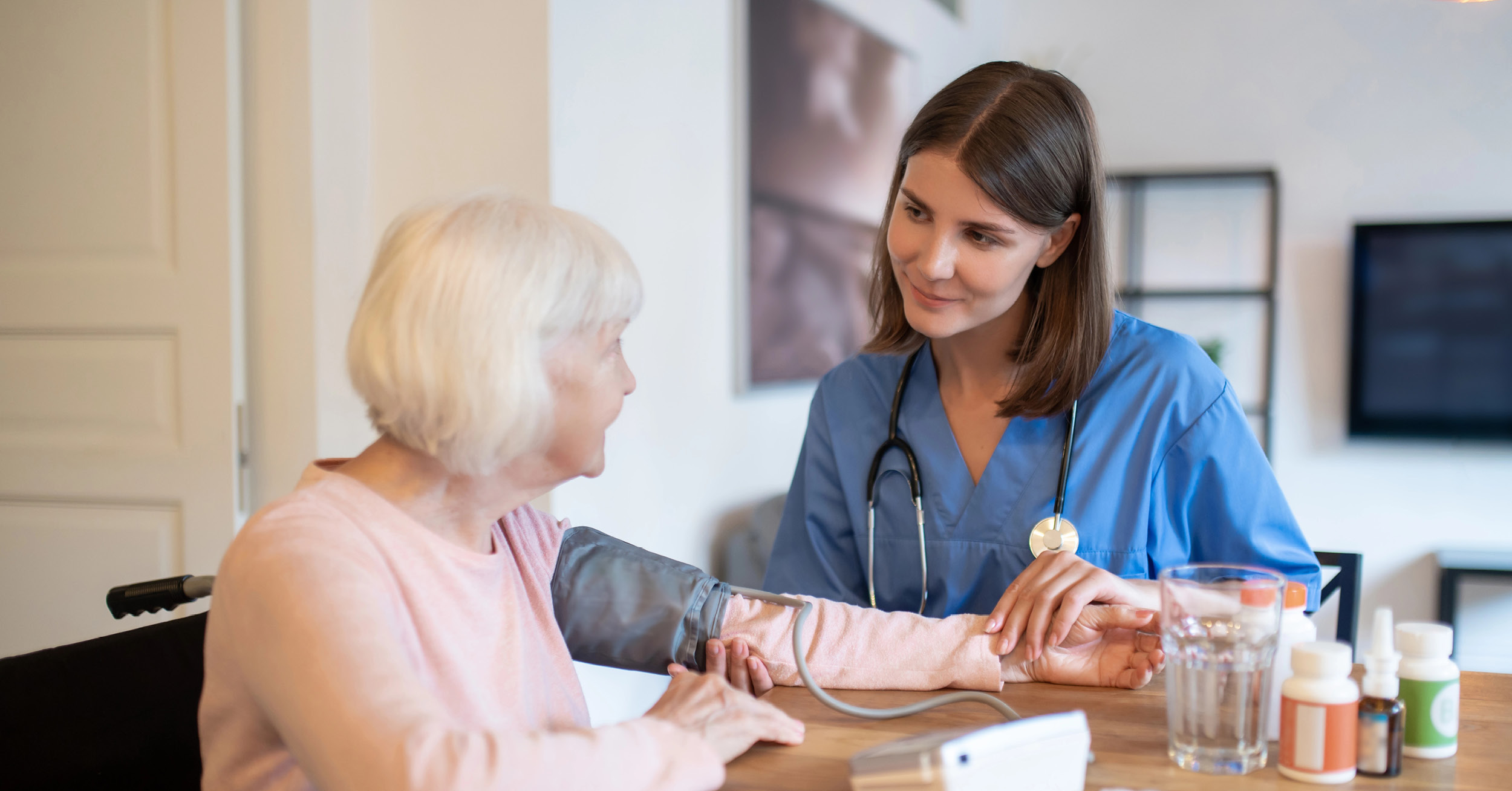 caregiving taking blood pressure of patient